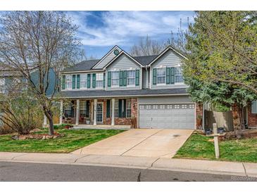 Charming two-story home with a well-maintained front yard, green shutters and a two car garage at 2225 Clayton Cir, Superior, CO 80027