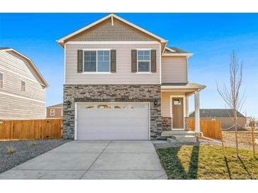 Charming two-story home with stone accents and a two-car garage, presenting a welcoming curb appeal at 18029 Dandy Brush Ln, Parker, CO 80134