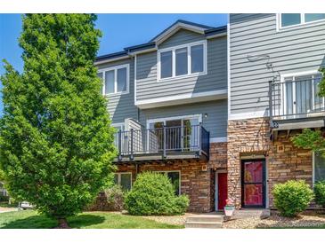 Charming townhome with stone accents, a balcony, manicured lawn and mature shade tree at 2763 W Riverwalk Cir # B, Littleton, CO 80123