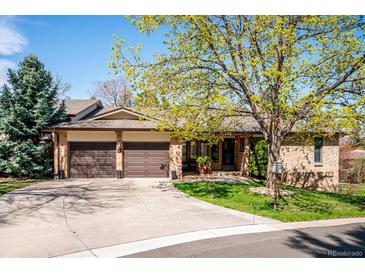 Charming home with a well-manicured lawn, mature tree, and a convenient two-car attached garage at 2615 Oak Dr # 7, Lakewood, CO 80215