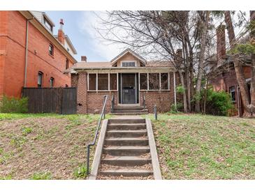 Charming brick home with a welcoming front porch and steps leading to the entrance at 1445 Saint Paul St, Denver, CO 80206