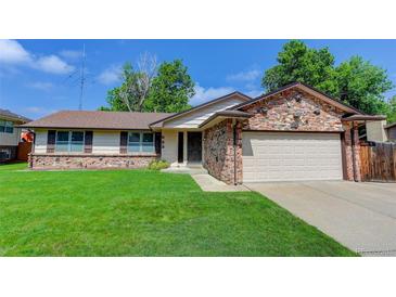 Charming single Gathering home features stone accents and a well-maintained lawn at 633 S Galena St, Denver, CO 80247