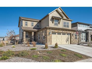 Beautiful two-story home featuring a stone facade, attached two-car garage, and well-manicured landscaping at 8137 Ralston Creek Ave, Littleton, CO 80125