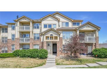 Attractive townhome with brick accents, balconies, and well-maintained landscaping at 5714 N Gibralter Way # 5-204, Aurora, CO 80019
