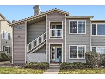 Inviting townhome with gray siding, private entrance, and well-maintained landscaping at 8358 Pebble Creek Way # 204, Highlands Ranch, CO 80126