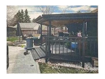 Cozy backyard covered patio with black wood features and gravel at 110 S Hoyt St, Lakewood, CO 80226