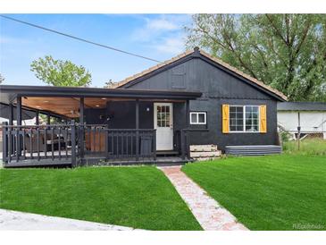 Charming, renovated home with a manicured lawn and covered deck for outdoor relaxation at 110 S Hoyt St, Lakewood, CO 80226
