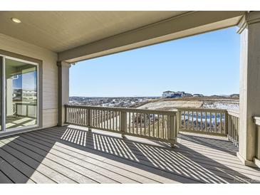 Spacious covered deck showcasing scenic views of the surrounding landscape and distant mountains at 3856 Treadway Pt, Castle Rock, CO 80108