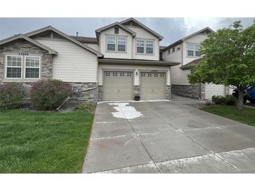 Two-story home with two-car garage and landscaped front yard at 23080 York Ave, Parker, CO 80138