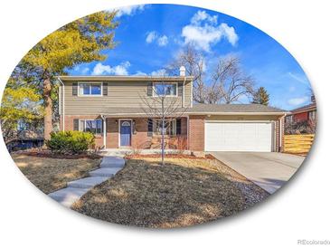 Charming two-story home features a well-maintained lawn and a two-car garage at 6720 S Adams Way, Centennial, CO 80122