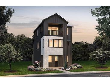 Charming two-story home with a modern design, stylish exterior, and well-manicured lawn at 8625 Hotchkiss St, Littleton, CO 80125