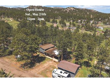 Beautiful home nestled amongst mature trees with mountain views and a large RV or boat parking area at 29827 Gigi Rd, Evergreen, CO 80439