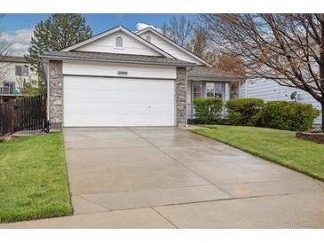 Charming single-Gathering home featuring a two-car garage, stone accents and well-manicured lawn at 22070 Day Star Dr, Parker, CO 80138