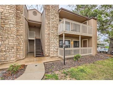 Charming multi-story condo building with stone accents, wood trim, and inviting outdoor balconies at 10293 E Peakview Ave # F104, Englewood, CO 80111