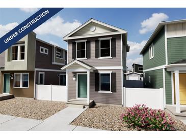 Two-story craftsman style home with gray siding, white trim, and landscaping at 10306 Uvalda Ct, Commerce City, CO 80022
