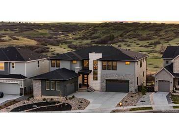 Beautifully landscaped two-story home boasts modern architecture and mountain views at 7611 Copper Sky Ct, Castle Pines, CO 80108