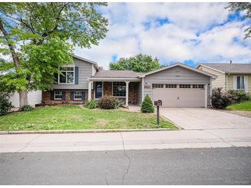 Charming two-story home with a well-manicured lawn, mature trees, and a two-car garage at 1962 S Ivory Way, Aurora, CO 80013