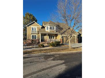 Two-story house with a large front porch and attached two-car garage at 6297 W Prentice Ave, Littleton, CO 80123