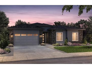 Craftsman style home with stone accents and a two-car garage at 8841 S Quemoy St, Aurora, CO 80016