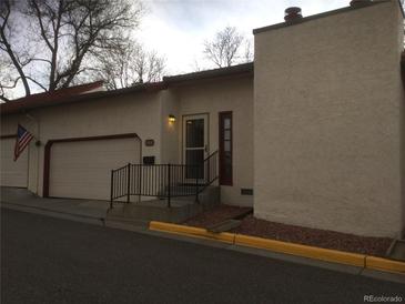 Charming townhouse featuring a convenient attached garage and landscaped front entrance at 1511 Belero St, Broomfield, CO 80020