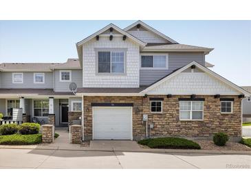 Charming townhome featuring stone accents, a one car garage and inviting curb appeal at 14000 Winding River Ct # T3, Broomfield, CO 80023