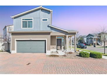 Inviting two-story home with a two car garage, brick driveway, and well-maintained landscaping at 20017 E 48Th Pl, Denver, CO 80249