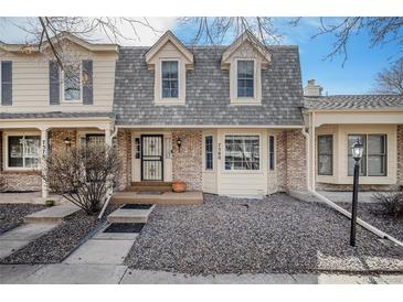 Charming townhome featuring a well maintained front exterior with a stone front yard at 7580 S Cove Cir, Centennial, CO 80122