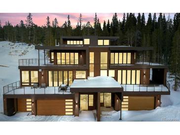 Modern, multi-story home with balconies, and mountain views surrounded by snow at 310 N Fuller Placer Rd, Breckenridge, CO 80424