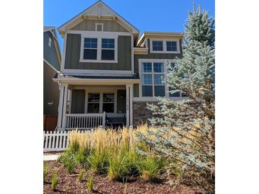 Charming two-story home featuring a cozy front porch and well-manicured landscaping at 13788 Umatilla Ln, Broomfield, CO 80023