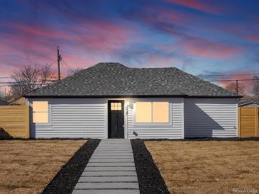 Charming home showcasing a well-maintained front yard with a inviting walkway at 4947 Saint Paul St, Denver, CO 80216