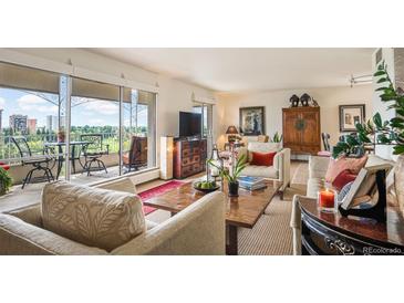 Bright living room with floor-to-ceiling windows, beautiful golf course view, and elegant furniture at 1200 N Humboldt St # 1406, Denver, CO 80218