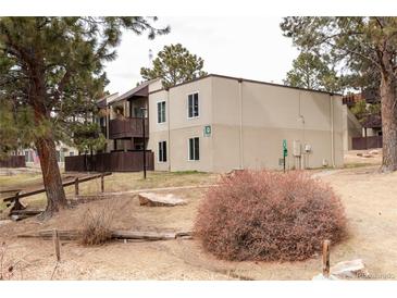 Condo exterior featuring neutral siding, a private balcony, and a well-maintained grassy area at 9995 E Harvard Ave # 257, Denver, CO 80231