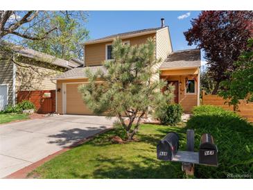 Charming home with a well-maintained lawn, mature trees, and a two-car attached garage at 938 W Peakview Cir, Littleton, CO 80120