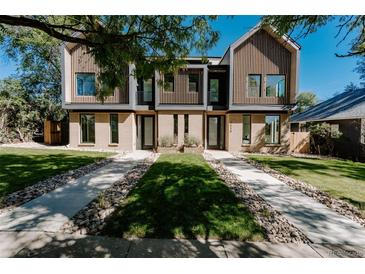 Modern three-story townhome featuring a beautifully landscaped front yard and symmetrical walkway at 2530 Chase, Edgewater, CO 80215