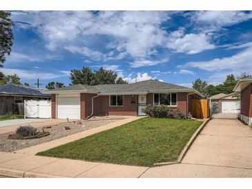 Charming brick home featuring a well-manicured front lawn, attached garage, and inviting curb appeal at 1785 S Zuni St, Denver, CO 80223