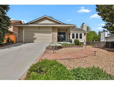 Charming single-Gathering home with stone accents, a two-car garage, and a beautifully landscaped front yard at 7466 E Long Cir, Centennial, CO 80112