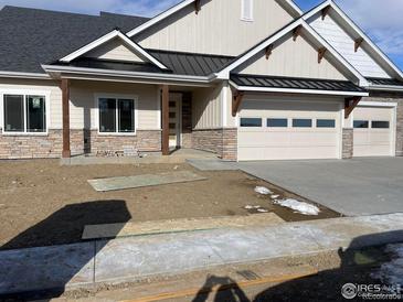 New construction home with stone accents and a two-car garage at 1402 Burt Ave, Berthoud, CO 80513