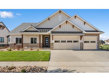 Charming single-Gathering home with two-car garage, stone accents, and a well-manicured front lawn at 1402 Burt Ave, Berthoud, CO 80513