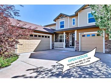 Inviting home featuring a multi-car garage, stone accents, and an open house banner in the driveway at 10646 Amesbury Way, Highlands Ranch, CO 80126