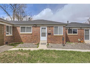 Charming brick home with well-maintained lawn, sidewalk, and front door under a partly cloudy sky at 1537 Xenia St, Denver, CO 80220