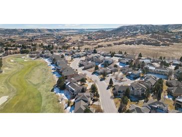 Wonderful aerial view of the home and surrounding neighborhood with golf course and mountain views at 2059 June Ct, Castle Rock, CO 80104