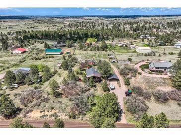 Expansive aerial view of the property showcasing the home, surrounding landscape and neighborhood at 7715 Rafter Rd, Franktown, CO 80116
