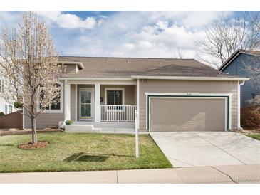 Charming home featuring a two-car garage, well-maintained lawn, and neutral-tone siding at 9640 Sydney Ln, Highlands Ranch, CO 80130