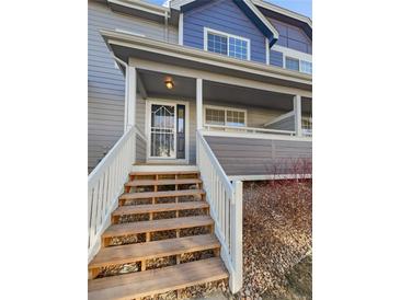 Inviting exterior with stairs leading to a charming front porch at 1335 S Danube Way # 105, Aurora, CO 80017