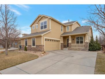 Charming two-story home with stone accents, covered porch, and attached two car garage at 1017 Mircos St, Erie, CO 80516