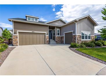 Charming home with a two-car garage, stone accents, and a well-manicured lawn and driveway at 26722 E Peakview Pl, Aurora, CO 80016