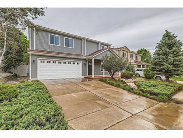 Charming two-story home with a well-maintained lawn, wide driveway, and two-car garage at 5120 Perth St, Denver, CO 80249