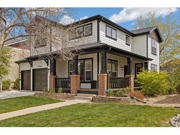 Charming two-story home with a covered front porch, landscaped lawn, and a two-car garage at 10938 Mcclellan Rd, Parker, CO 80134