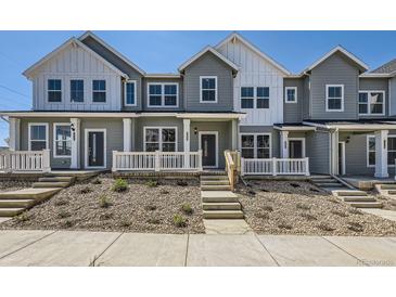 Charming townhome with covered porch, professional landscaping, and inviting curb appeal at 2002 S Haleyville Way, Aurora, CO 80018