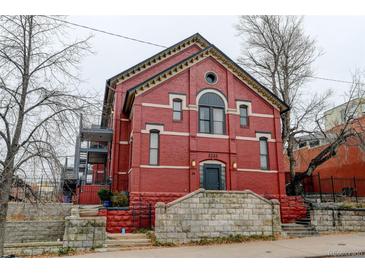 Brick building exterior with a stone wall and steps at 3233 Osage St # 2A, Denver, CO 80211